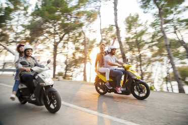 Two couples riding mopeds along coastal road, Split, Dalmatia, Croatia - CUF27741