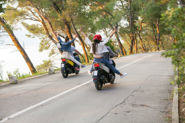 Rear view of two couples riding mopeds on rural road, Split, Dalmatia, Croatia - CUF27765