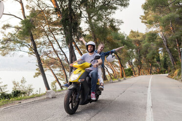Couples riding moped on rural road, Split, Dalmatia, Croatia - CUF27766