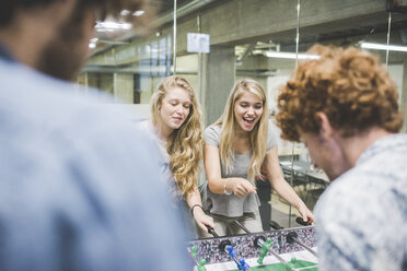 Co-workers playing foosball at break - CUF27856