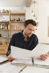 Woman looking at paperwork - CUF27920