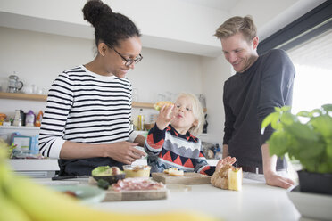 Family preparing food in kitchen - CUF28017