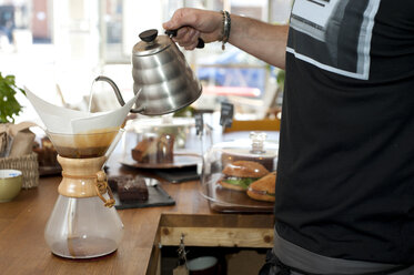 Close up of filter coffee brewing kit and kettle, cafe barista preparing  filter at the counter Stock Photo by benzoix