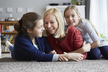Happy mother and daughters having fun at home - RBF06284