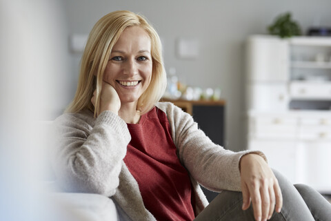 Happy woman relaxing at home stock photo