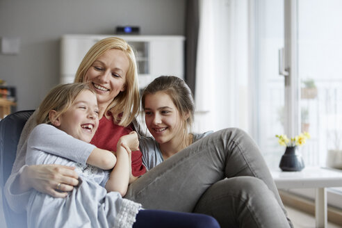 Happy mother and daughters having fun at home - RBF06296