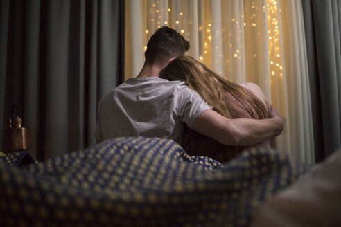 Romantic young couple sitting on bed - AWF00052