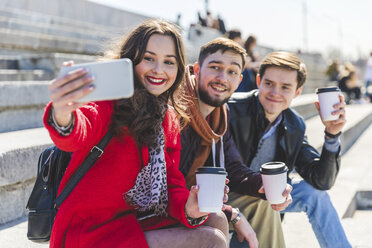 Russia, Moscow, group of friends taking a selfie and showing their cups of coffee - WPEF00410