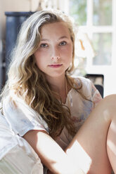 Portrait of pretty teenage girl on sofa - CUF28641