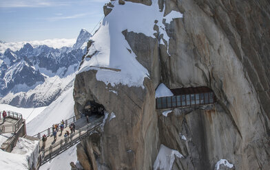 Tourists crossing bridge at Aguille du Midi, Mont Blanc, Chamonix, Haute Savoie, France - CUF28793