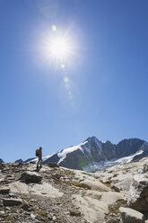 Austria, Carinthia, hiker watching Grossglockner peak and high alpine territory - GWF05538