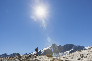 Austria, Carinthia, hiker watching Grossglockner peak and high alpine territory - GWF05539