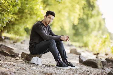 Portrait of young man sitting in nature - JATF01043