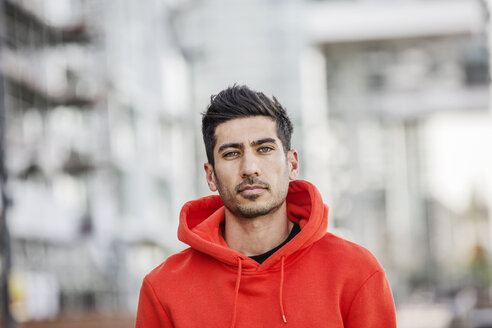 Portrait of fashionable young man wearing red hooded jacket - JATF01045