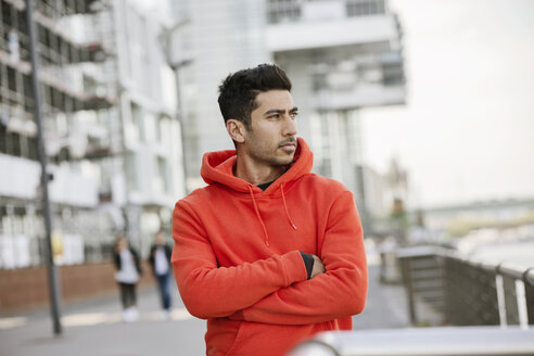 Portrait of fashionable young man wearing red hooded jacket - JATF01046