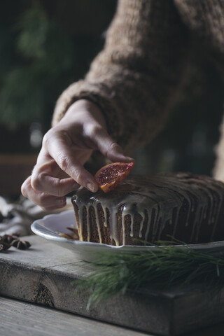 Frauenhand dekoriert selbstgebackenen Weihnachtskuchen, lizenzfreies Stockfoto