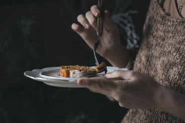 Woman eating home-baked Christmas cake, partial view - ALBF00383