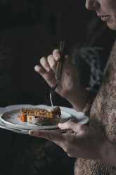 Woman eating home-baked Christmas cake, partial view - ALBF00384