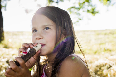 Portrait of girl blowing bird whistle in park - CUF29084