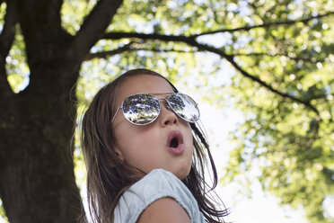 Portrait of girl wearing sunglasses in park - CUF29099