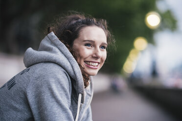 Portrait of happy female runner taking a break - CUF29213