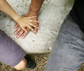 Overhead view of boys hand on top of fathers hand - CUF29272