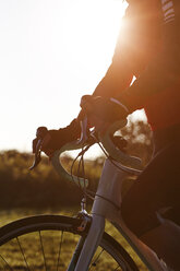 Cyclist riding during sunset - CUF29350