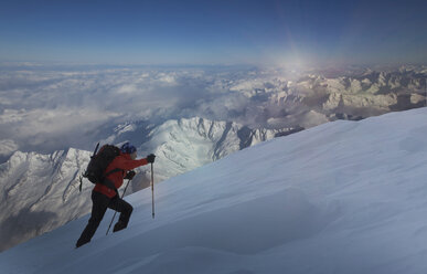 Climber moving up through deep snow, Swiss Alps, Canton Wallis, Switzerland - CUF29392
