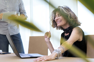 Senior businesswoman using laptop in office - CUF29508
