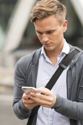 Man texting in street - CUF29766