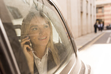 Businesswoman looking out of black cab, London, UK - CUF29769