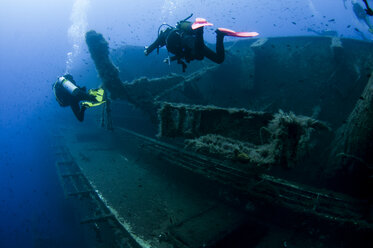 Underwater rear view of divers investigating MS Zenobia shipwreck, Larnaca, Cyprus - CUF30296
