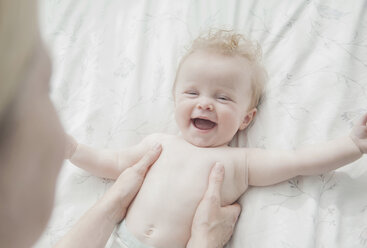 Mother and baby daughter face to face, laughing - CUF30650