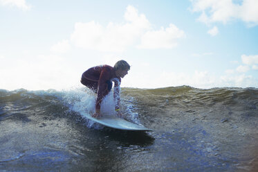 Male surfer riding wave - CUF30653