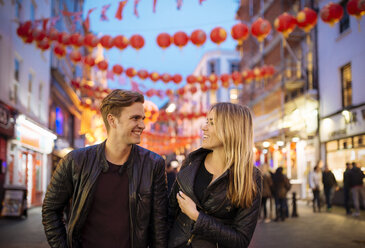 Young couple strolling at night, Chinatown, London, England, UK - CUF30780