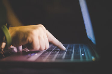 Side view of hand typing on laptop computer keyboard - CUF30851