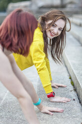 Young woman doing push-ups on steps - CUF30891