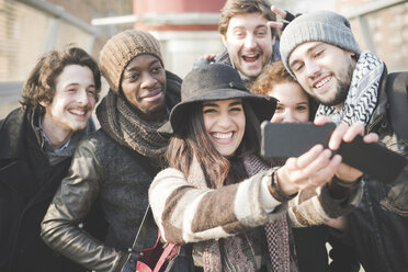 Six young adult friends taking selfie on smartphone - CUF31153