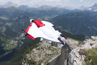 Zwei männliche BASE-Springer beim Absprung von einem Berggipfel, Dolomiten, Italien - CUF31203