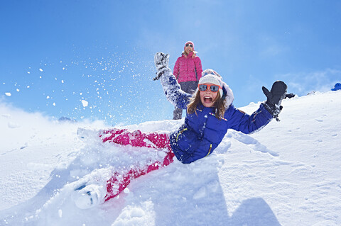 Mädchen fällt in den Schnee, Chamonix, Frankreich, lizenzfreies Stockfoto