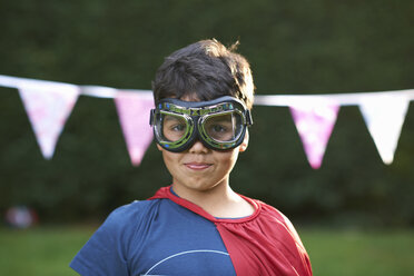Portrait of boy wearing goggles and cape, looking at camera - CUF31297