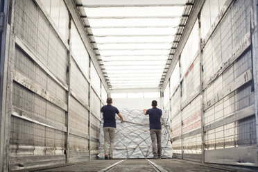 Workers pushing freight in air freight container - CUF31420