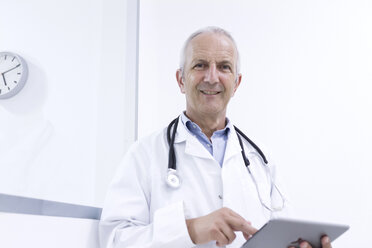 Portrait of male doctor using digital tablet - CUF31429