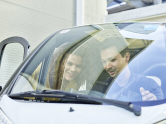 Smiling couple with electric bubble car - CVF00789