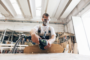 Mann schleift Skateboard in der Werkstatt - CUF31728