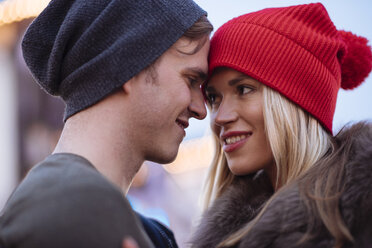 Head and shoulder shot of romantic young couple wearing knit hats - CUF31764