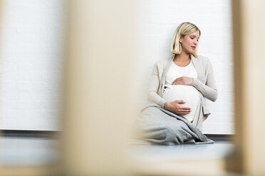 Full term pregnancy young woman sitting on floor - CUF31790