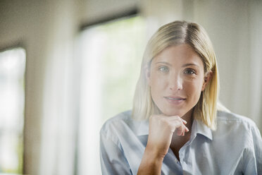 Portrait of beautiful young woman with chin on hand - CUF31802