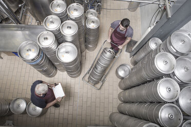 Brewers moving kegs in brewery - ISF09724