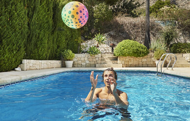 Junger Mann wirft Ball im Schwimmbad - CUF32148